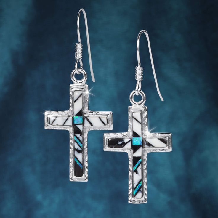 Crafted from sterling silver, this set features a cross pendant and matching earrings, each inlaid with the spiritual stone White Buffalo. This standout black and white stone was first discovered in the Dry Creek Mine, Tonopah, Nevada by the Otteson family in 1993. Symbolizing purity, strength and spirituality, White Buffalo stone adds a unique and meaningful touch to this set. Sterling Silver Cross Jewelry With Matching Earrings, Spiritual White Cross Jewelry, Spiritual Sterling Silver Crucifix Jewelry, Black Sterling Silver Crucifix Jewelry, Black Symbolic Cross Pendant Jewelry, Symbolic Black Cross Pendant Jewelry, White Sterling Silver Cross Jewelry, Black Sterling Silver Jewelry With Inlay, White Southwestern Sterling Silver Jewelry