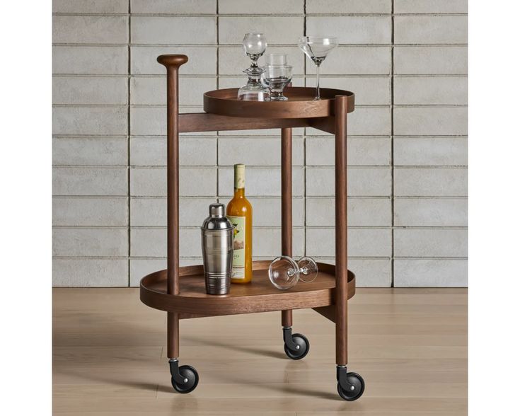 a wooden bar cart with wine glasses and bottles