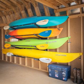 there are many kayaks hanging from the ceiling