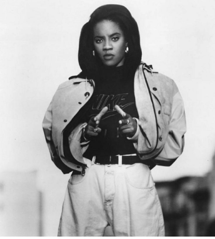 a black and white photo of a woman wearing a jacket