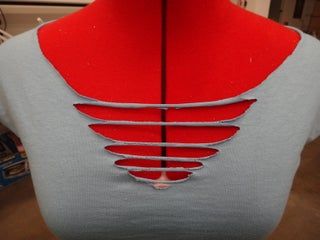 the back of a dress with red and grey details