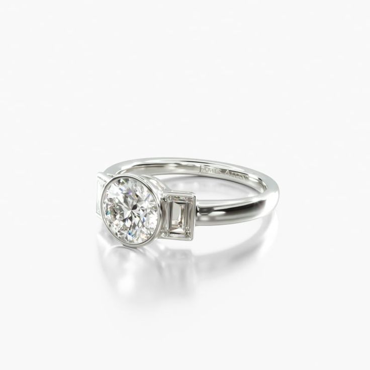 an engagement ring with a baguett cut diamond in the center, on a white background