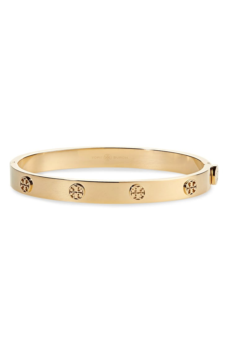 Logo medallions lend a stunning signature element to this gleaming goldtone bangle. Style Name:Tory Burch Miller Hinge Bracelet. Style Number: 6143216. Braclets Gold, Tory Burch Watch, Tory Burch Bracelet, Hinge Bracelet, Preppy Jewelry, Us Fashion, The Sweetest Thing, Tory Burch Jewelry, Sweetest Thing