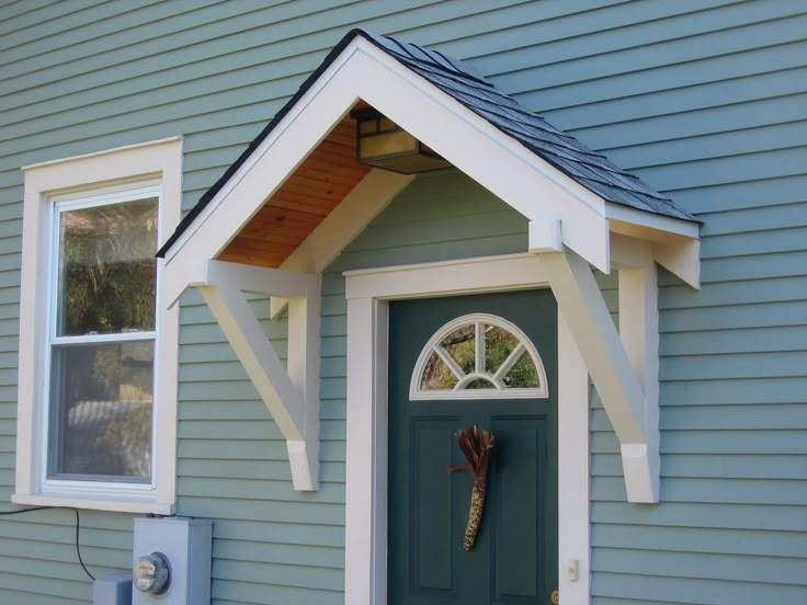 a blue house with a green door and white trim