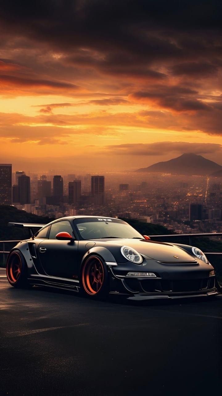 a black sports car parked on top of a parking lot in front of a city