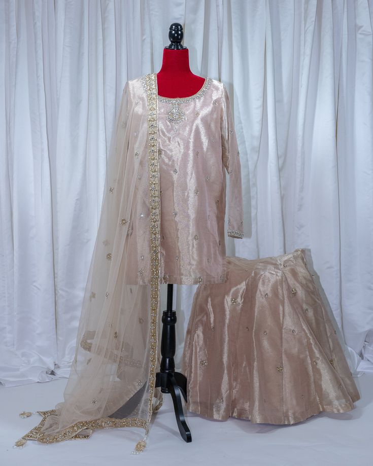 An intricately crafted formal set with the lighter dupatta. 3 pieces. Elegant Lawn Suit With Dabka For Wedding, Elegant Naqshi Sharara For Festivals, Elegant Gold Sharara With Naqshi, Elegant Gold Naqshi Sharara, Elegant Lehenga With Naqshi For Festive Occasions, Elegant Gold Sharara With Naqshi Detailing, Elegant Naqshi Lehenga For Festive Occasions, Designer Organza Palazzo Set For Party, Fashionable Organza Palazzo Set For Party