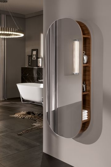 a bathroom with an oval mirror on the wall