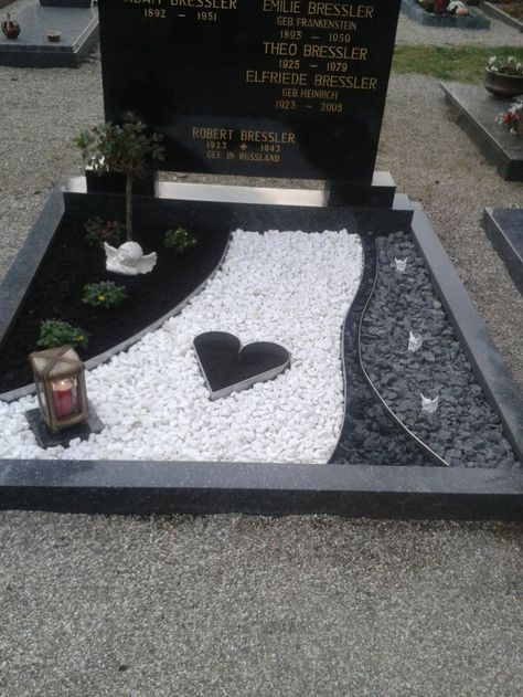 a grave with a heart on the ground