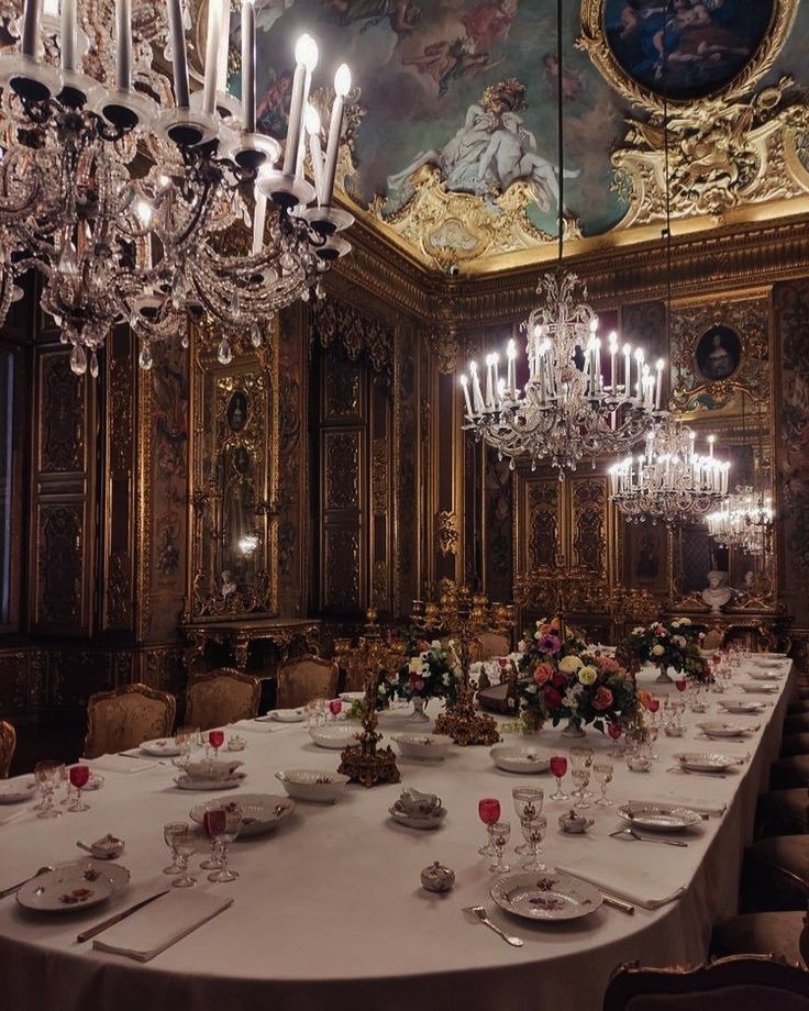 a fancy dining room with chandeliers and tables