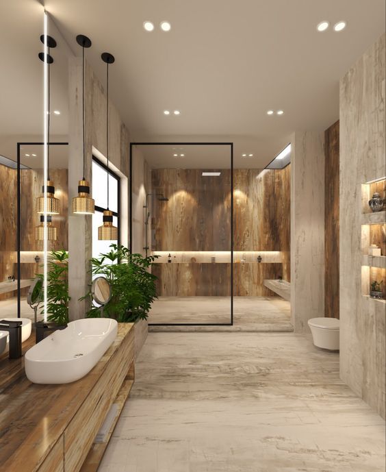 a large bathroom with two sinks, mirrors and a plant in the middle of the room