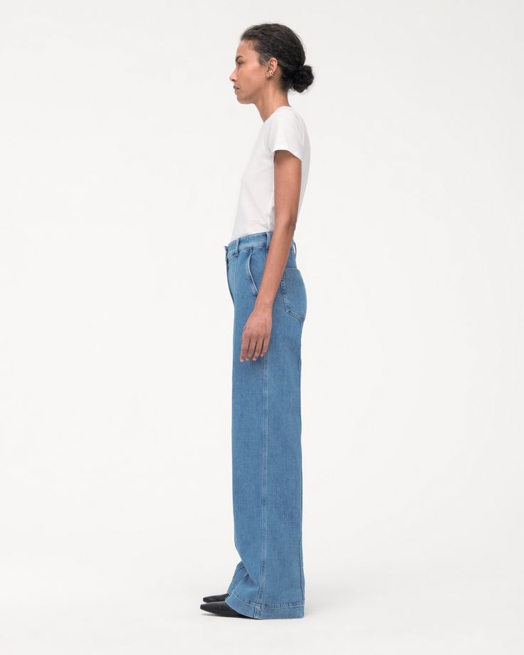 High-waisted, with a straight leg fit, these pants have a slimming effect enhanced by elongating front seams extending from thigh to ankle. A double hook and bar closure with an interior button provide a clean finish in the front, while the back is fit to provide lift and shape.Our denim is made from organic cotton processed in a GOTS-Certified Italian mill. We’ve invested in working with a responsible denim mill that measures their impact and uses data to push the industry forward. They’ve deve Classic High Rise Wide Leg Pants, Spring Denim Blue Flare Jeans With Seam Detailing, Spring Flare Jeans With Seam Detailing, Classic Blue Flare Jeans With Straight Hem, Relaxed Fit Denim Blue Flare Jeans For Work, Modern Medium Wash Full Length Bottoms, Modern Full-length Bottoms In Medium Wash, Classic Denim Wide Leg Pants For Spring, Modern Full-length Medium Wash Bottoms