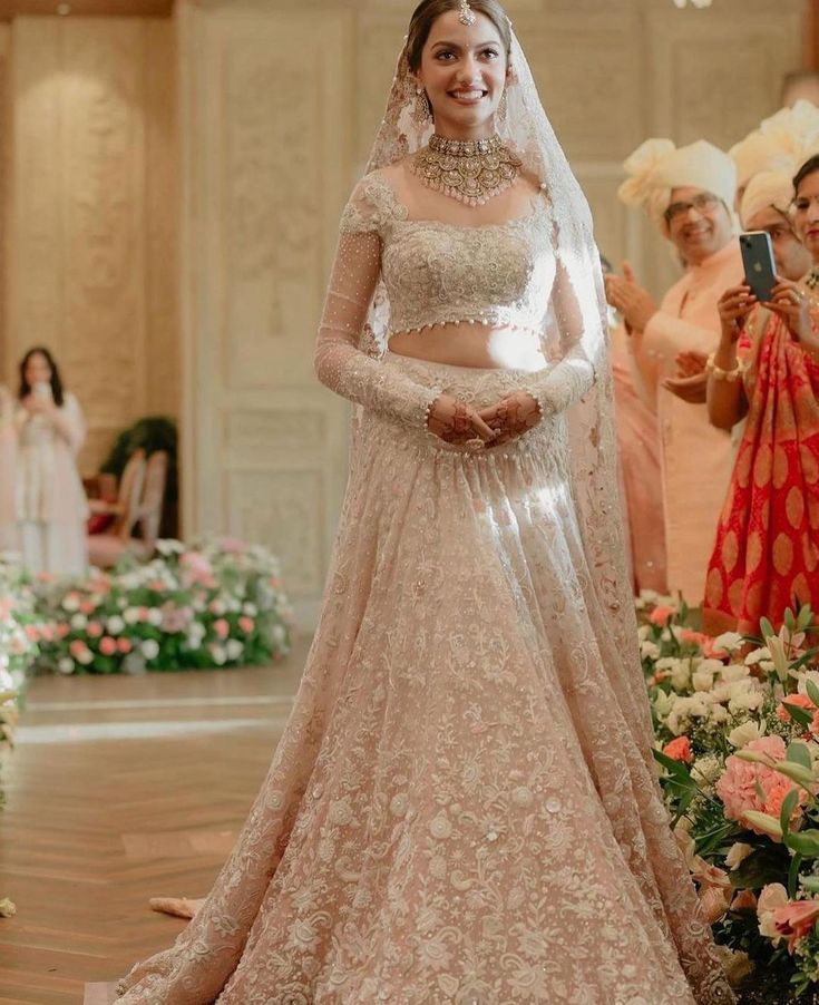 a woman in a wedding dress standing next to flowers