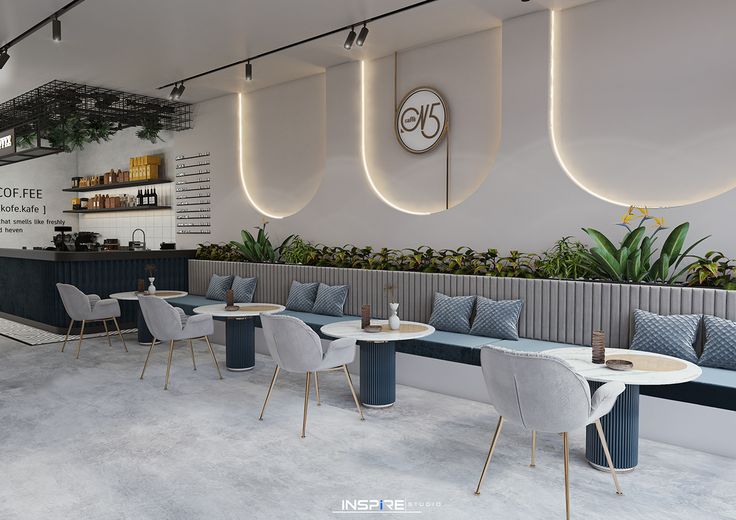 the interior of a restaurant with blue and white chairs, tables and planters on the wall