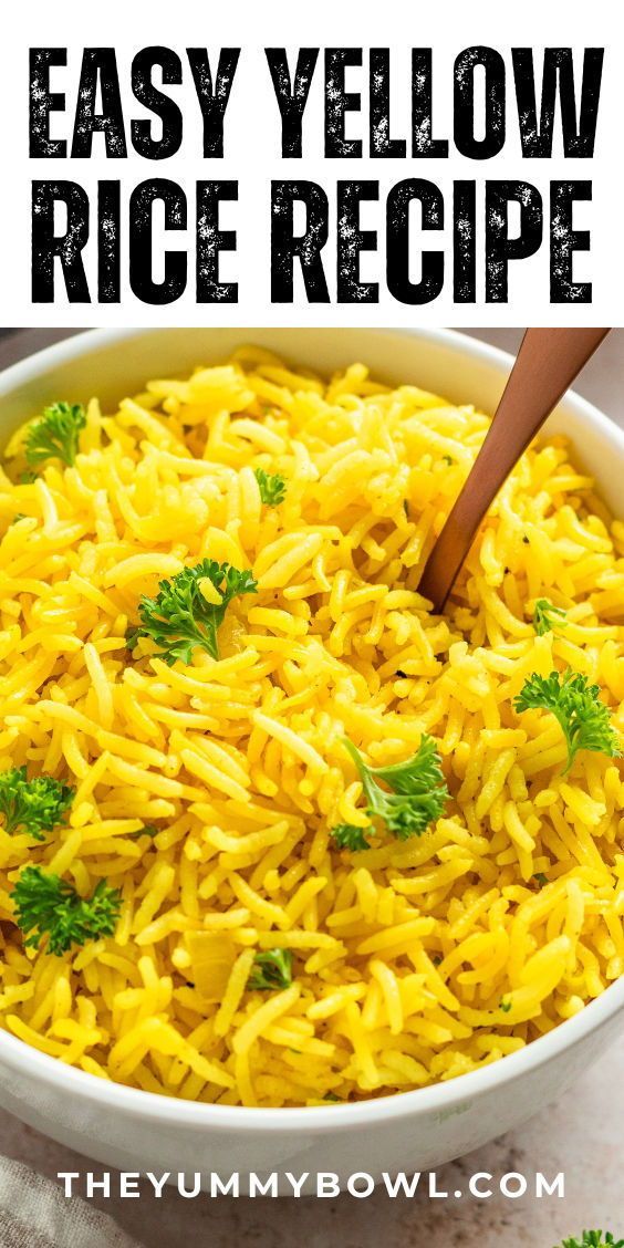 a bowl filled with yellow rice and garnished with parsley in the middle