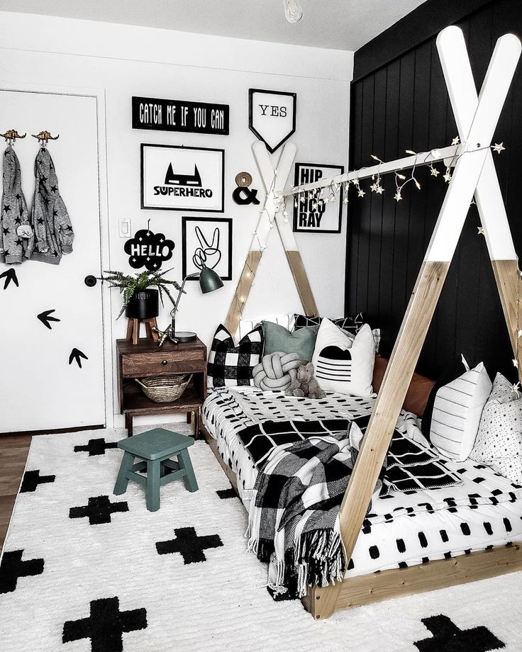 a bedroom with black and white decor on the walls, bedding, and rugs