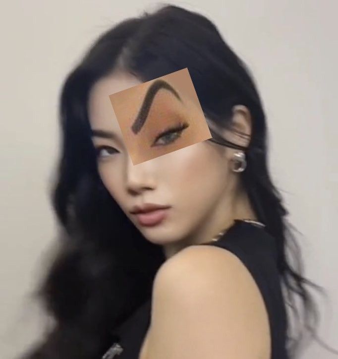 a woman with long black hair has a piece of paper on her face and eyebrows