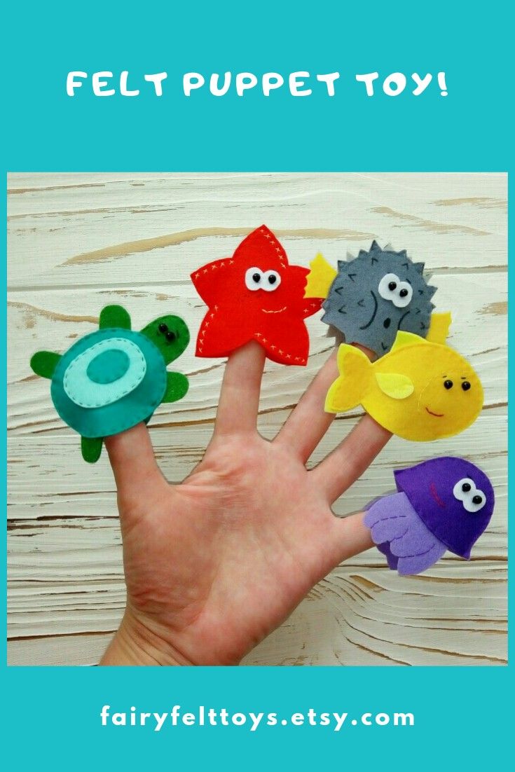 a hand with five felt toy sea animals on it