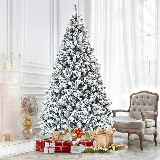 a white christmas tree with presents under it