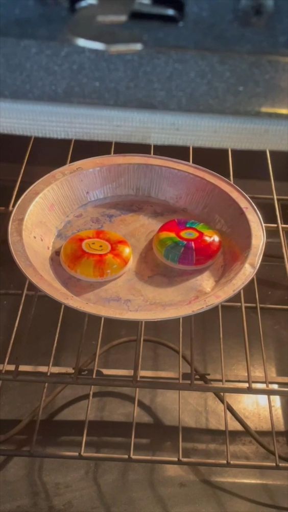 two colorful donuts in a white bowl on an oven rack