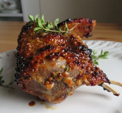 a piece of meat is on a plate with some garnish and parsley