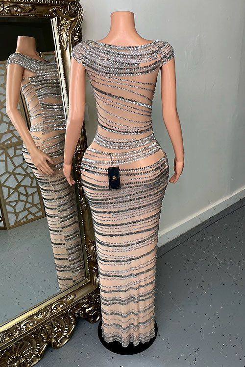 a mannequin wearing a dress made out of sequins in front of a mirror