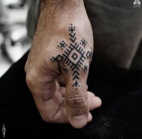 a person with a tattoo on their hand