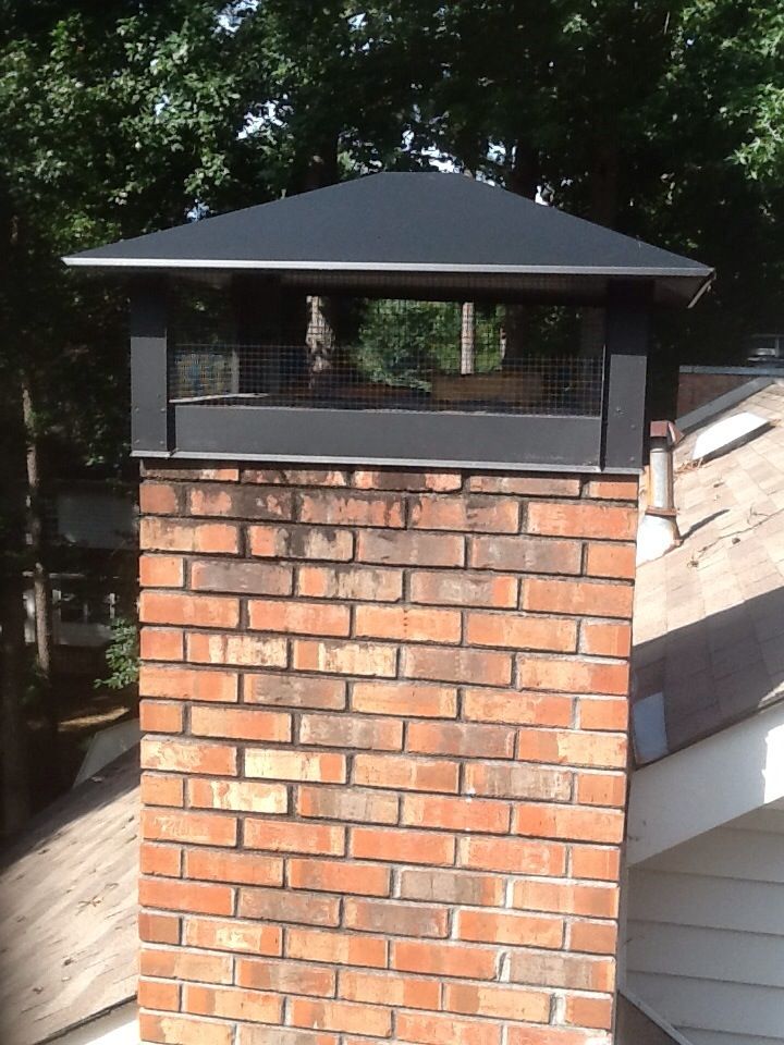 a brick fire place with a black roof