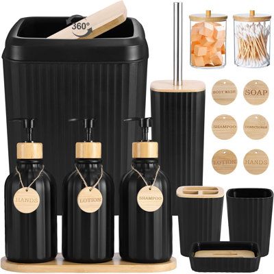 black bathroom accessories including soap dispenser, toothbrush holder and cups