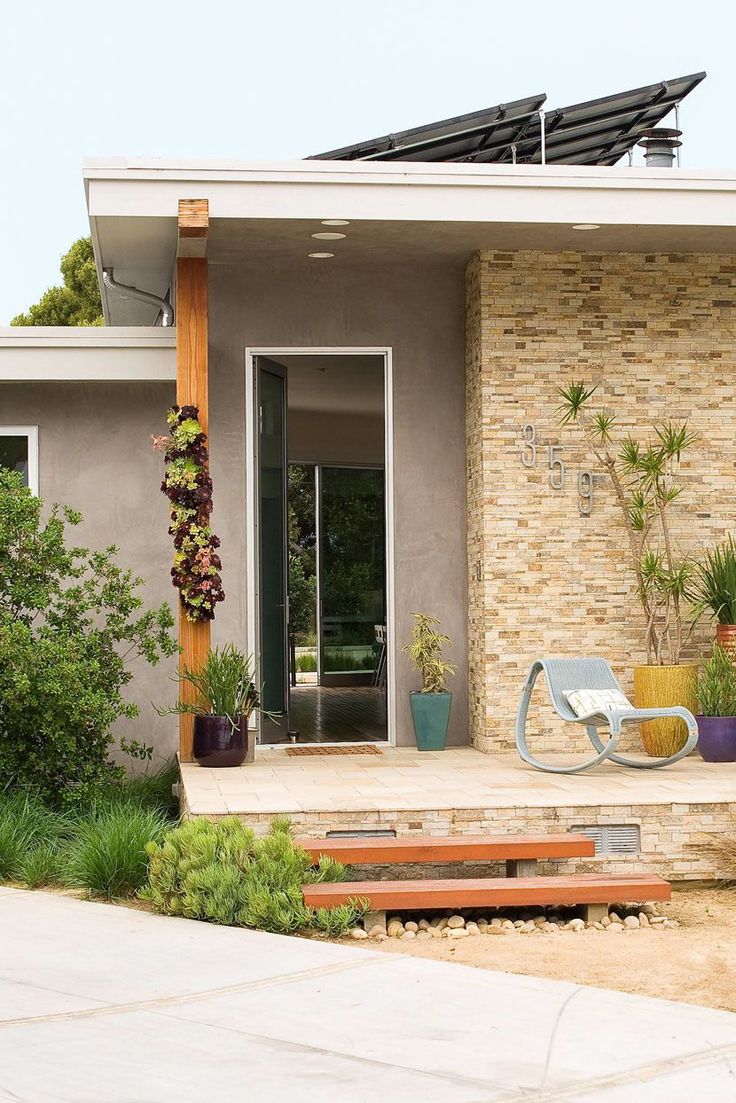 a modern house with an outdoor patio and seating area