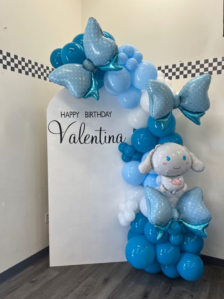 a blue balloon elephant sitting on top of a bunch of balloons in front of a sign that says happy birthday valentine