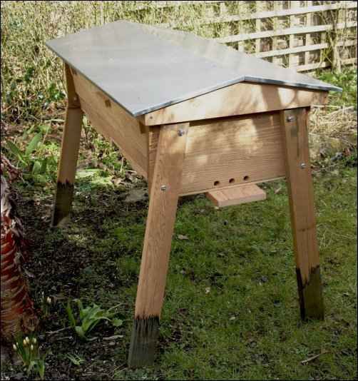 a wooden table sitting in the grass