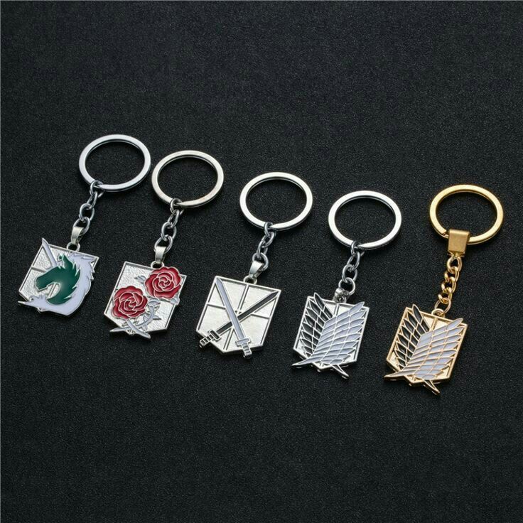 five different metal keychains with the symbols on them