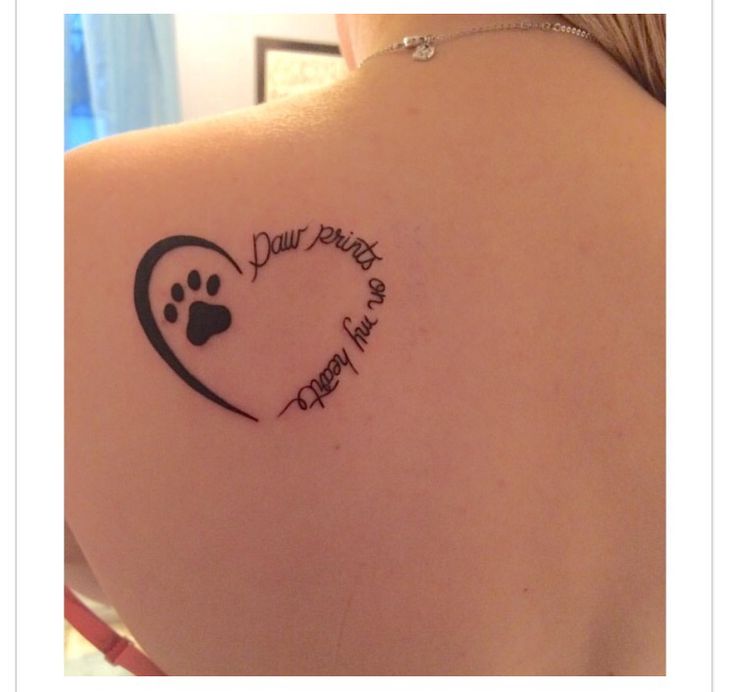 the back of a woman's shoulder with a tattoo on it