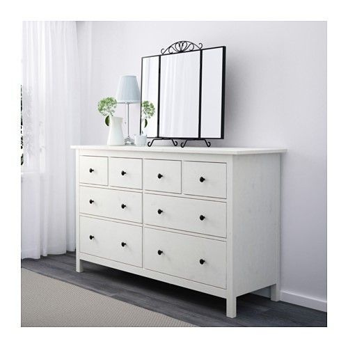 a white dresser and mirror in a room