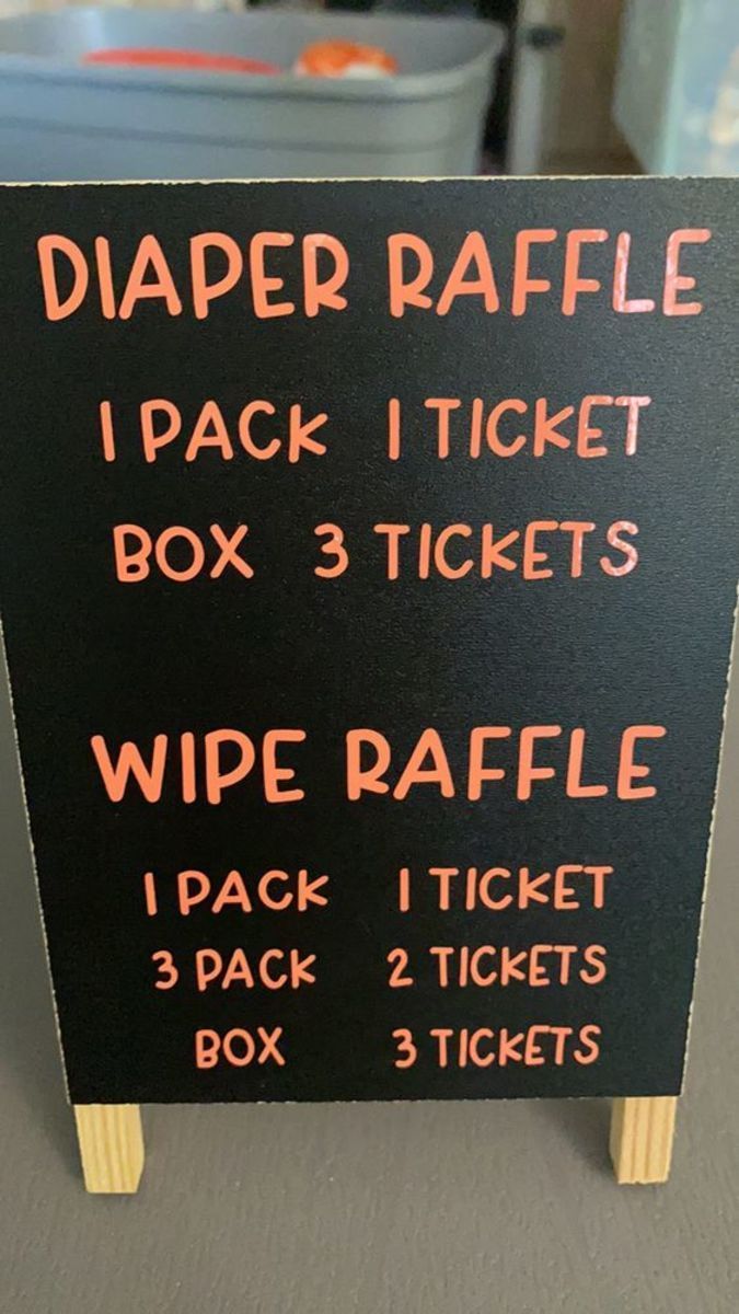 a sign with instructions for diaper raffle