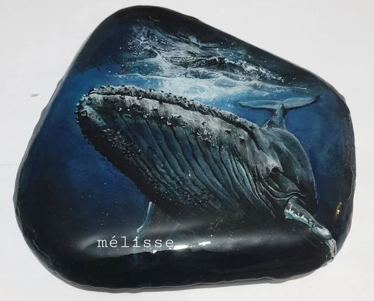 a rock with a whale painted on it