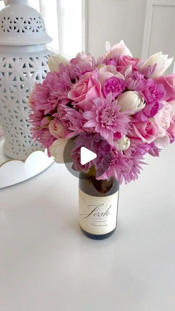 a vase filled with pink flowers on top of a table