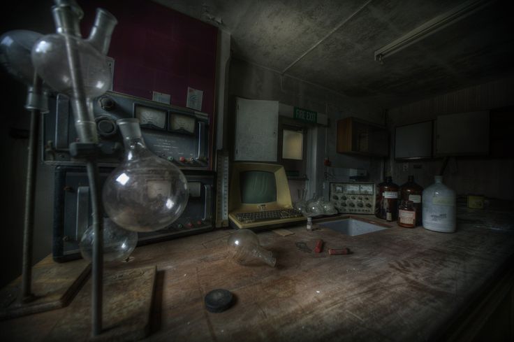 an old fashioned kitchen with lots of clutter on the counter and appliances in it