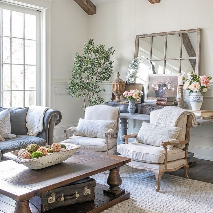 a living room filled with furniture and a mirror