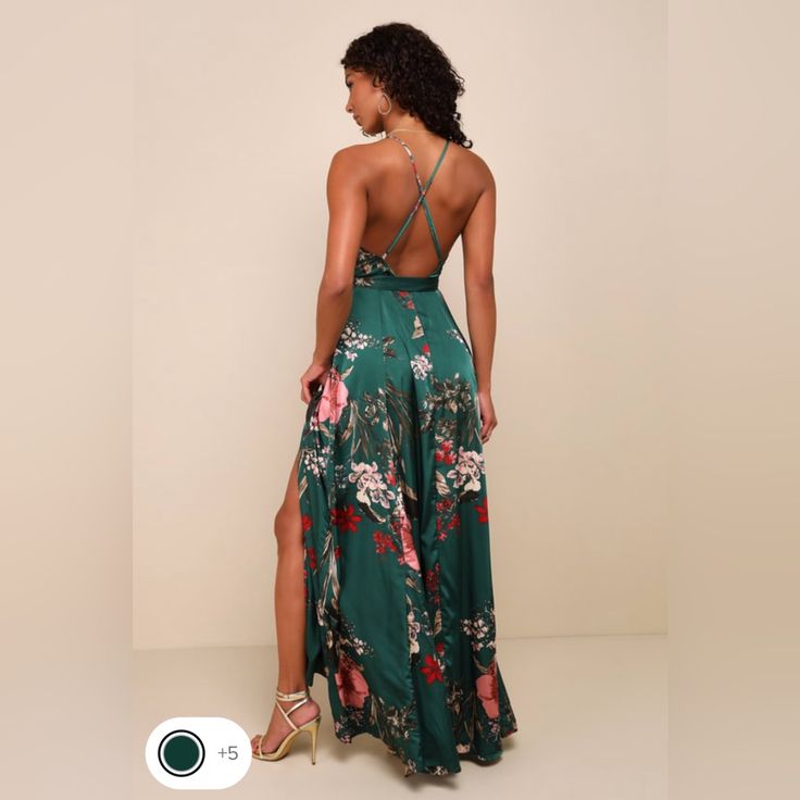 a woman in a green floral print dress with her back turned to the camera,