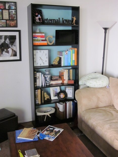 a living room with a couch, coffee table and bookshelf