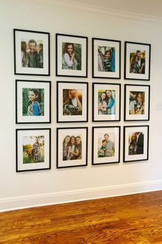 a wall with many pictures on it and a wooden floor in front of it,