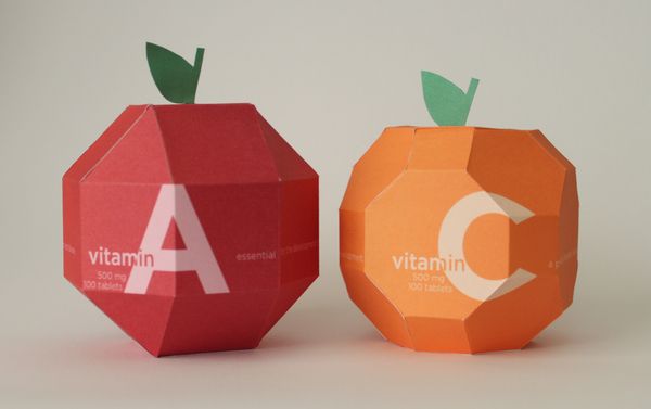 two paper apples with the letter a and an apple shaped like one sitting next to each other