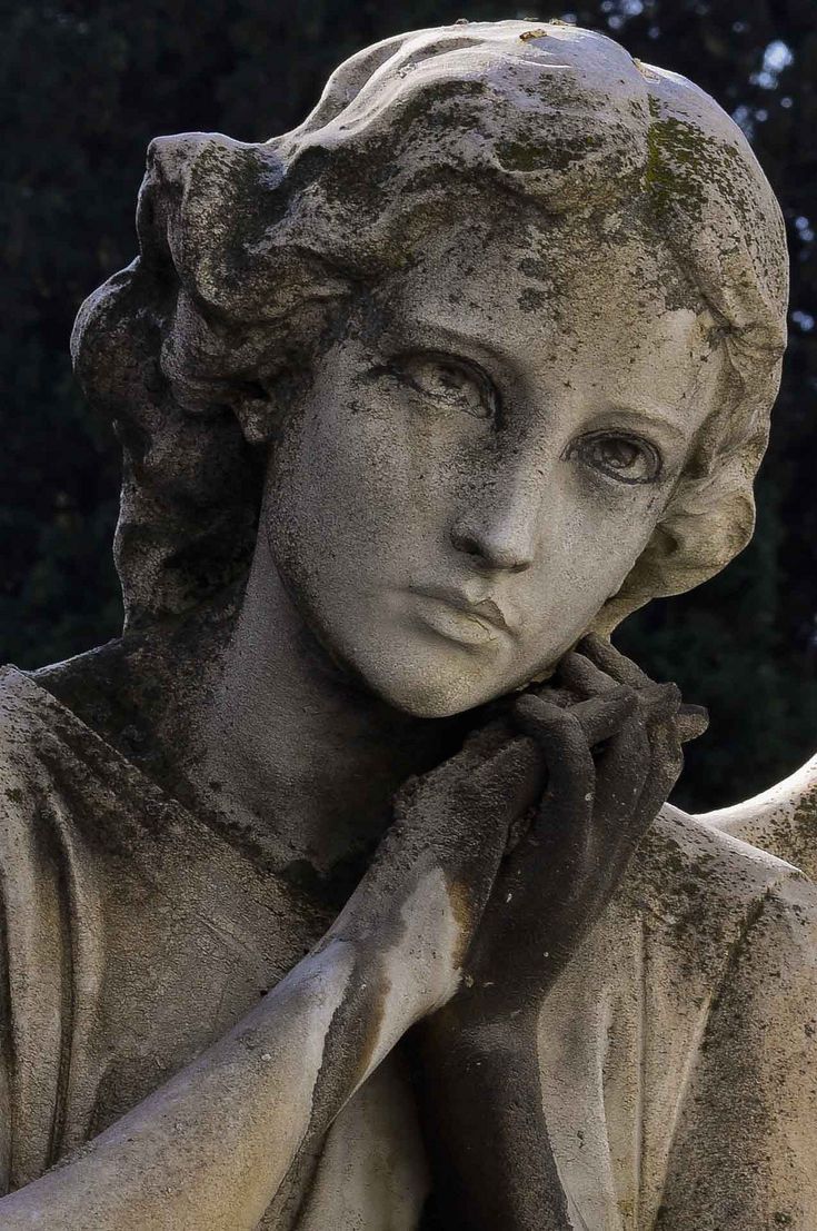 a close up of a statue of a woman with her hand on her chin and looking off to the side