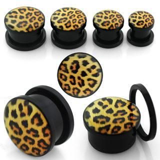 an assortment of leopard print acrylic plugs and gauges with black bases