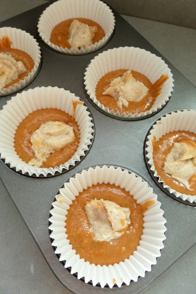 six cupcakes with peanut butter in them sitting on a baking tray, ready to be baked