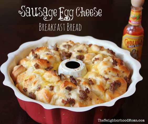 sausage egg cheese breakfast bread in a red casserole dish next to a bottle of mustard