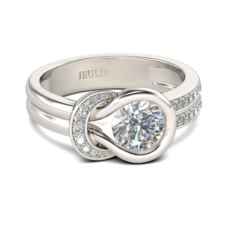 a white gold ring with diamonds on the side and an intertwined band around it