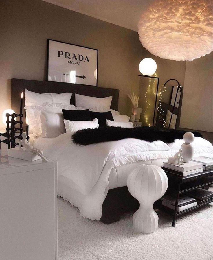 a bedroom with white and black decor on the walls, carpeted flooring and bedding