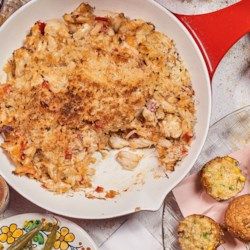 a white plate topped with food next to muffins